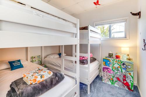 a bedroom with two bunk beds and a window at Canal-Front Home with Dock in Little Egg Harbor! in Little Egg Harbor Township