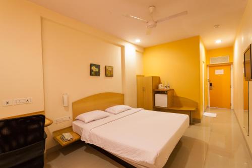 a bedroom with a white bed in a room at Ginger Guwahati in Guwahati