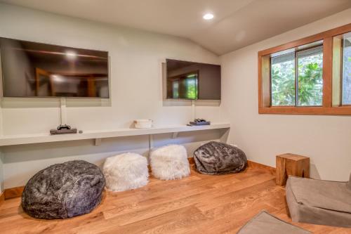Una sala de estar con dos pufs en el suelo. en Ski House 245 - Meredith Lodging, en Bend