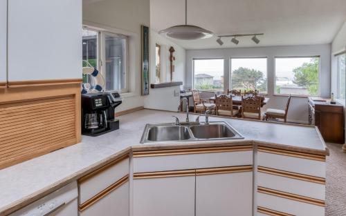 a kitchen with a sink and a table with chairs at The Boat House in Yachats