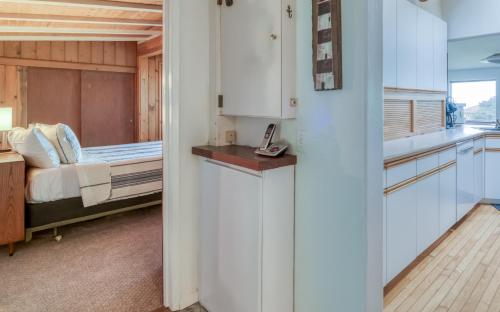 a kitchen and a bedroom with a bed at The Boat House in Yachats