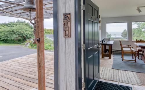 an open door to a patio with a table and chairs at The Boat House in Yachats