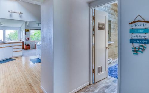 a kitchen and dining room with a door leading into a kitchen at The Boat House in Yachats