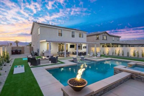 a backyard with a swimming pool and a house at Desert Encanto in Coachella