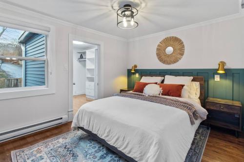 a bedroom with a large bed and a window at The Fancy House 3bed DT w Fenced Yard in St. John's