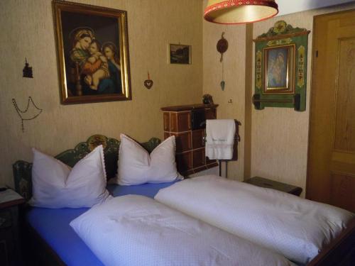 a bedroom with a large bed with white pillows at Almidylle Kathrin in Strobl