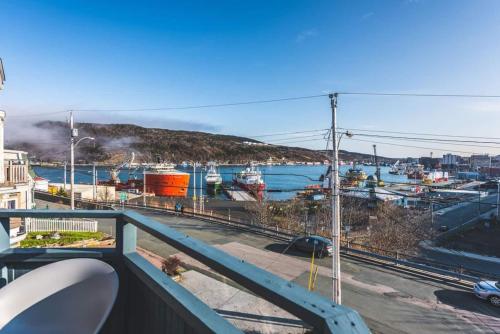 a balcony with a view of a marina at Harbour View Hitch 2BR w Parking & Deck in St. John's
