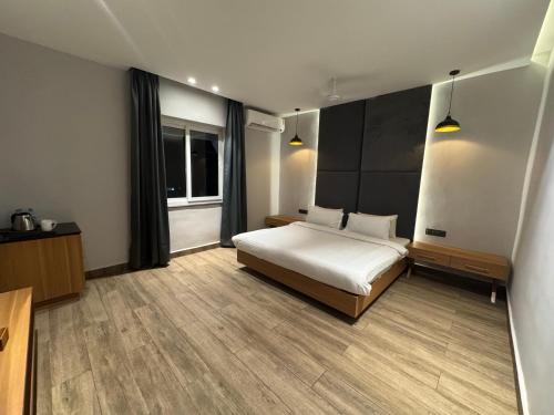 a hotel room with a bed and a window at The Beach House Candolim in Candolim