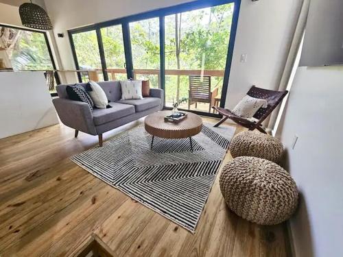 a living room with a couch and a table and chairs at Villa Sea Breeze in West End