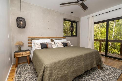 a bedroom with a bed and a large window at Villa Sea Breeze in West End