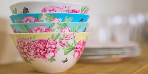 three bowls with flowers on them sitting on a table at Queens Suite 1bdrm in St. John's