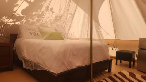 a bed in a tent with a sign on it at Bella Noni B&B in Aguadilla