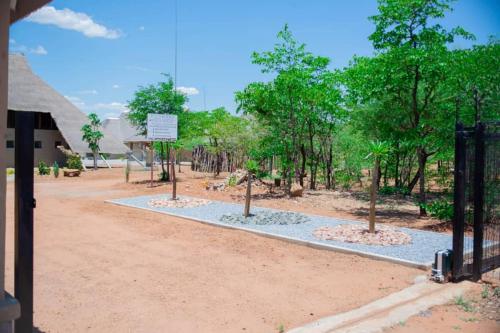 a zoo exhibit with trees and a fence at Kuswani Hotel in Sebina