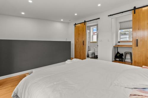 a bedroom with a large white bed in it at The Cabot 2bds 2ba Patio in St. John's