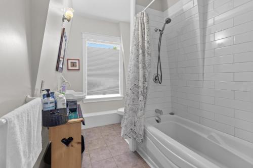 a white bathroom with a tub and a sink at Hamilton Hilltop Home3 King Bedsvictoria Park in St. John's