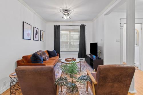 a living room with a couch and two chairs at The Fancy House 3bed DT w Fenced Yard in St. John's
