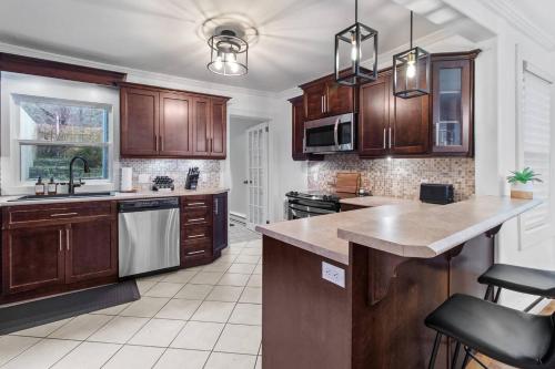 a kitchen with wooden cabinets and a counter top at The Fancy House 3bed DT w Fenced Yard in St. John's