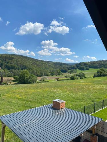 a building on top of a roof in a field at Ferienwohnung Auf der Höhe in Erbach im Odenwald