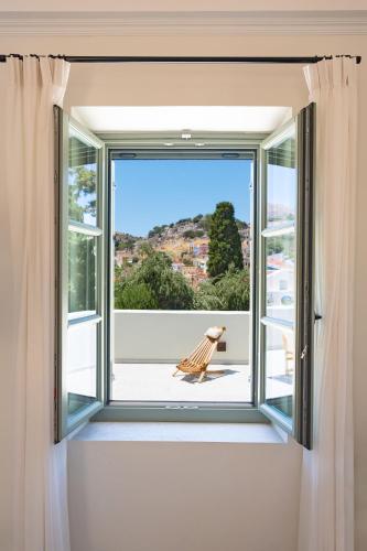 an open window with a view of a patio at Nisomar Suites in Symi