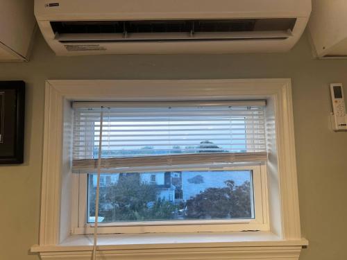 a window with a blind in a room at Private Penthouse Studio in Providence