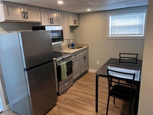 a kitchen with a stainless steel refrigerator and a table at Private Penthouse Studio in Providence
