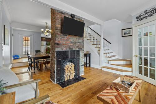 a living room with a fireplace and a tv at Historic Jelly Bean Row House Walk to Signal Hill in St. John's