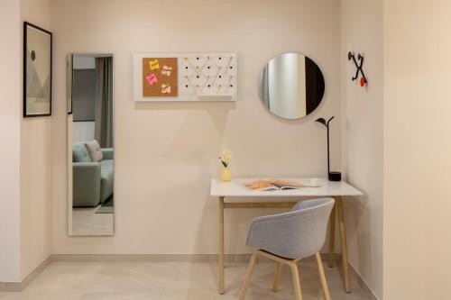 a room with a table and a mirror and a chair at Staybridge Suites Dubai Financial Centre by IHG in Dubai