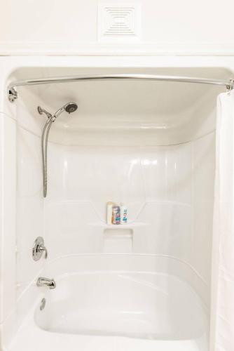 a bathroom with a tub and a sink at Harbour View Hitch 2BR w Parking & Deck in St. John's