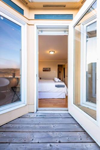a view of a bedroom from the balcony of a house at Harbour View Hitch 2BR w Parking & Deck in St. John's