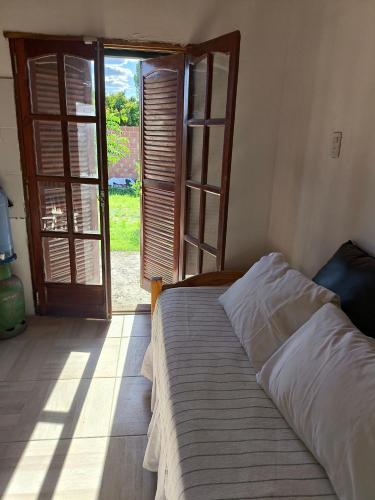 a bedroom with a bed and an open door at Las Carolas in Santa María