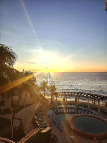a view of a resort with a swimming pool and the ocean at SUNSET FISHERMEN BEACH & SPA RESORT-Optional All Inclusive- 3 UNITS CHOICE-ROOM - 344A Ocean view with terrace- ROOM 344B No terrace, View from window to park - STUDIO 344C Ocean View Studio for 2- Playacar Beach, Phase 1-NO ELEVATOR! in Playa del Carmen
