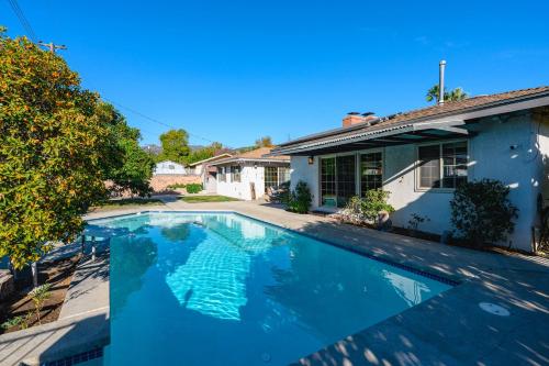 a swimming pool in front of a house at Luxury Estate with Sparkling Pool & Elegant Amenities in Glendora