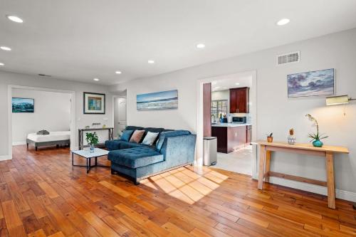 a living room with a blue couch and a table at Luxury Estate with Sparkling Pool & Elegant Amenities in Glendora