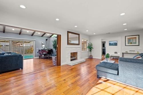 a living room with two couches and a fireplace at Luxury Estate with Sparkling Pool & Elegant Amenities in Glendora