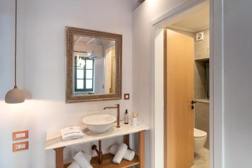 a bathroom with a sink and a mirror at Nisomar Suites in Symi