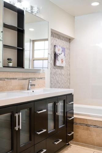 a bathroom with a sink and a mirror at Luxury Estate with Sparkling Pool & Elegant Amenities in Glendora