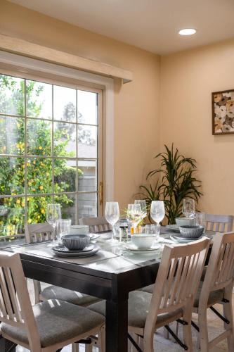 a dining room with a table and chairs and a window at Luxury Estate with Sparkling Pool & Elegant Amenities in Glendora