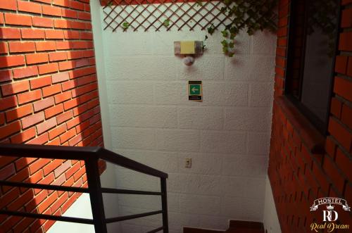 a stairway with a brick wall and a stair case at Real Dream Hostel in San Gil