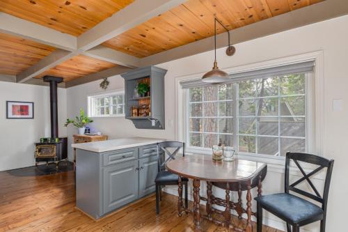 a kitchen with a table and chairs and a window at Fernwood in Arnold