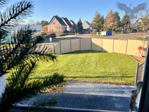 a view of a yard with a fence at River Lake Inn - Muldestausee in Pouch