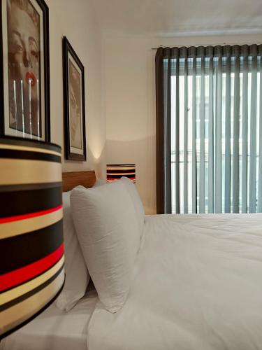 a bedroom with a bed with two pillows and a window at Sea Esta 2 in Il-Gżira
