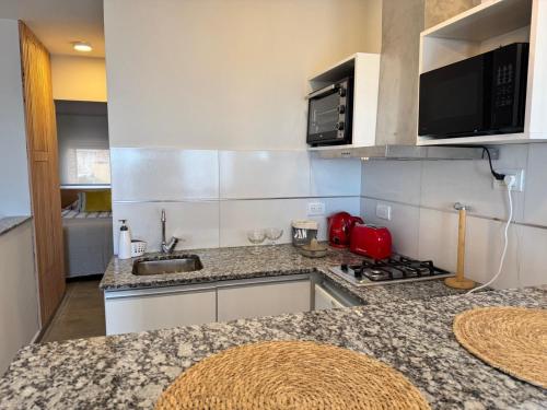 a kitchen with a sink and a counter top at Al Mare in Monte Hermoso