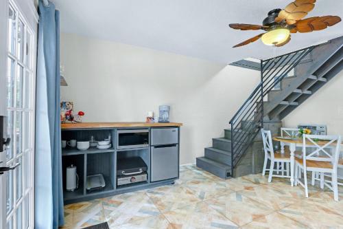 a living room with a staircase and a ceiling fan at Lakeview A-Frame in Canyon Lake