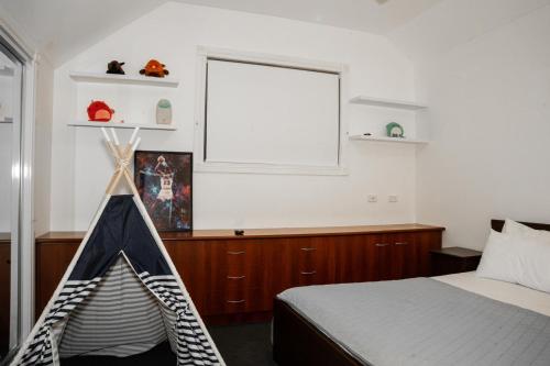 a bedroom with a bed and a window at A Gem in Strathtulloh in Exford