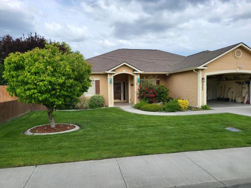 a house with a tree in the front yard at Tri-Cities Home Away from Home in Richland