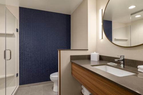 a bathroom with a sink and a mirror and a toilet at Fairfield by Marriott Inn & Suites Bethlehem PA in Bethlehem