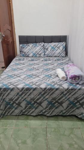 a bed with two pillows on it in a bedroom at Hotel Cristal in Barcarena