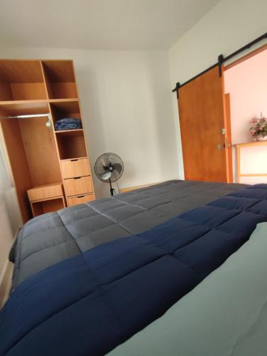 a bedroom with a blue bed and a closet at Bungalow Lomas de Cocoyoc in Oaxtepec
