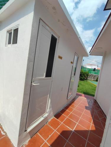 a room with a door and a patio at Bungalow Lomas de Cocoyoc in Oaxtepec