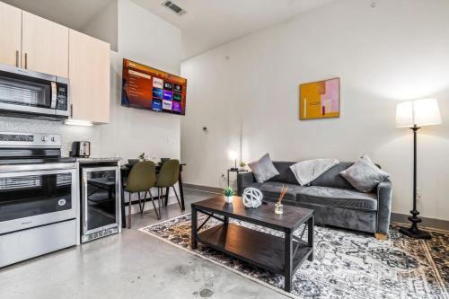 a living room with a couch and a table at Cozy Haven Steps Away from University Life in Fort Worth